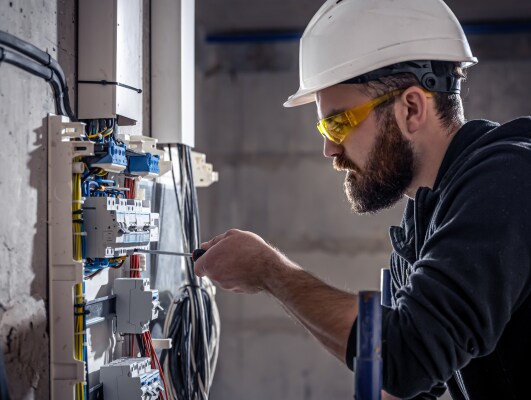 A maintenance worker fixing a MCB distribution board